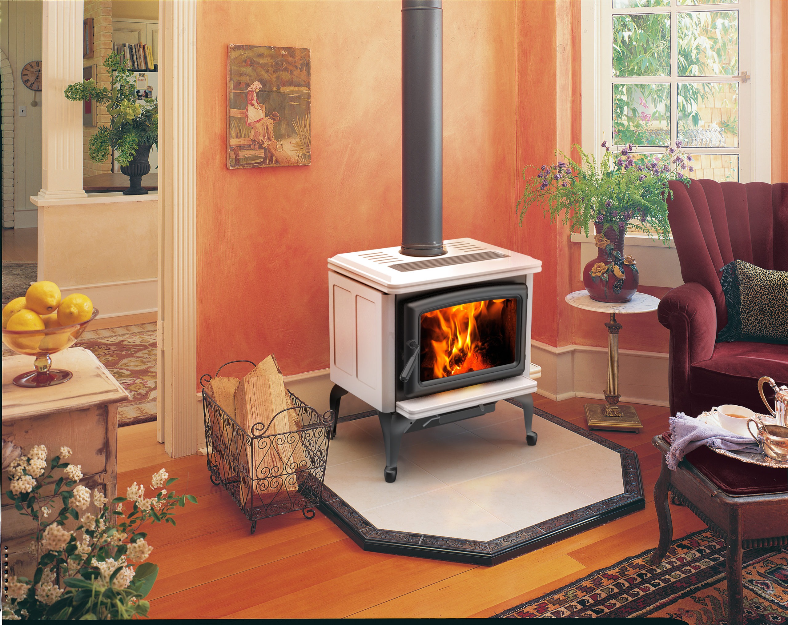 Vista Classic LE wood stove with Ivory porcelain enamel panels, metallic black legs, door and trivet